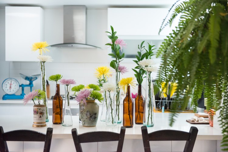 white counter, flowers, bottles, kitchen